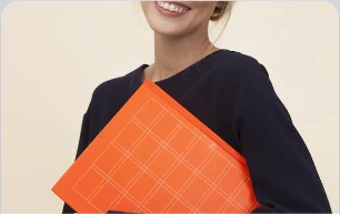 Smiling teacher holding an orange folder
