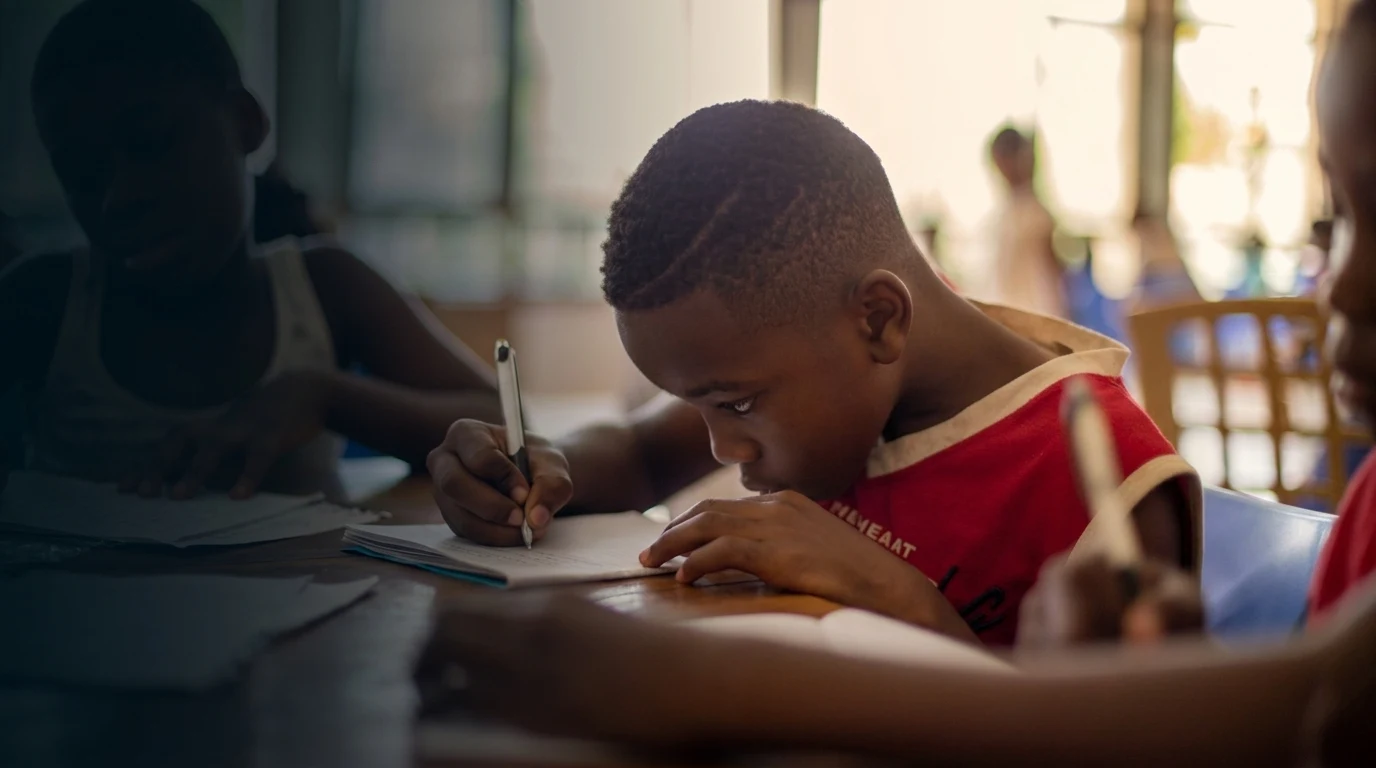 Student writing in classroom